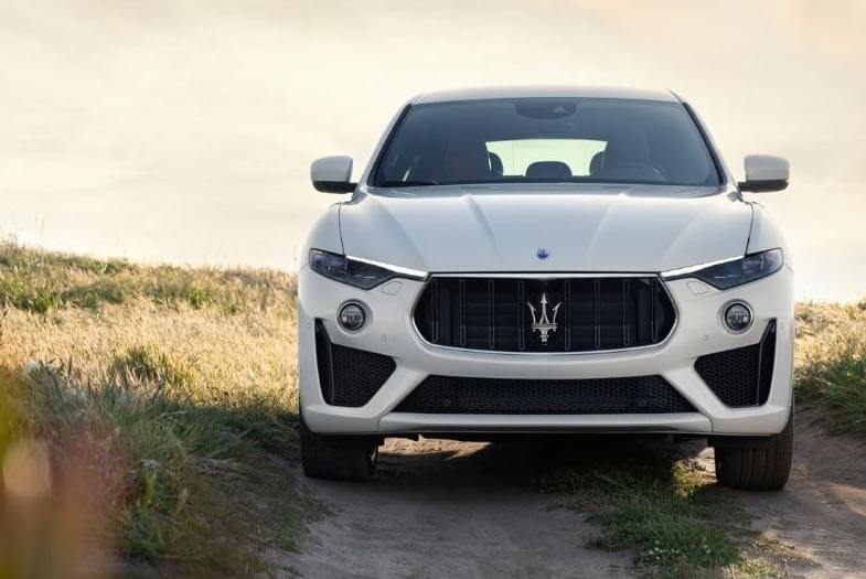 front three quarter view of a grey Maserati Levante GranSport SUV on a country road