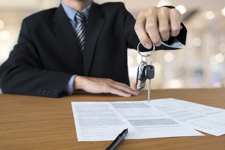 salesman handing over car keys