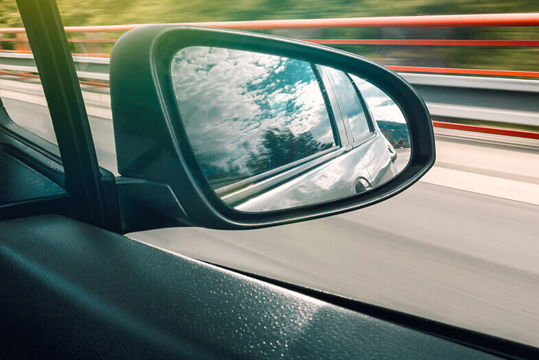 shot of side mirror or a moving car